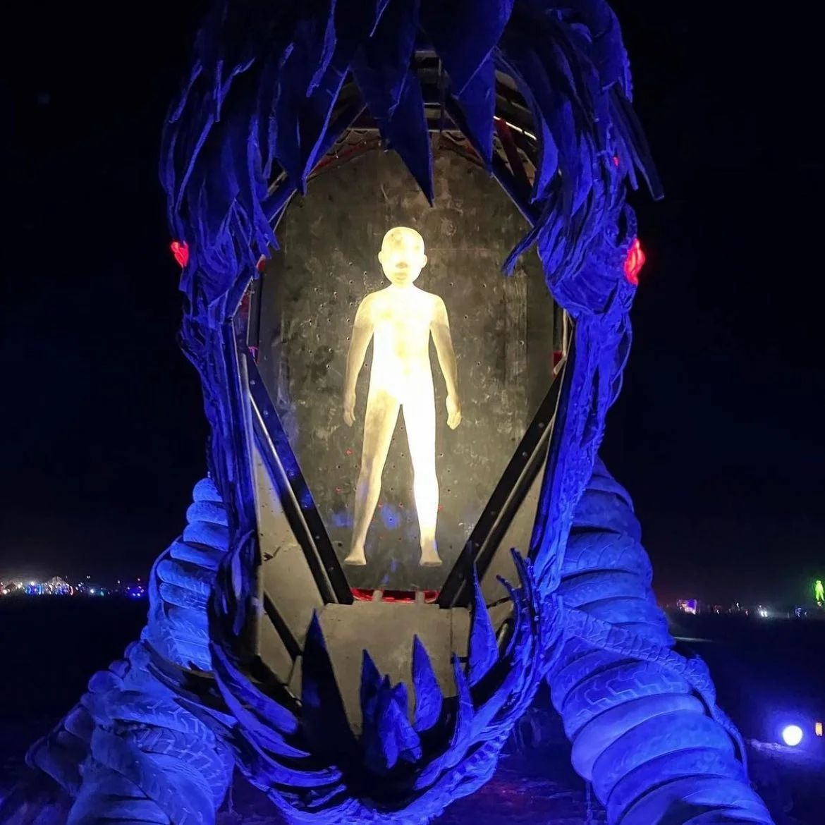 Illuminated child figure inside the Fearbeast's mouth at night with blue lighting